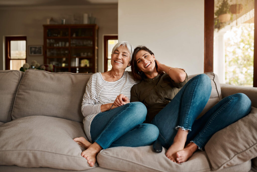 mom and daughter snuggling on couch